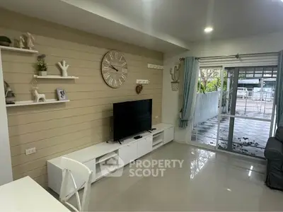 Stylish living room with modern decor and large window opening to a spacious balcony.