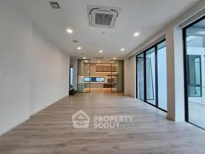 Spacious modern living room with open layout and large windows
