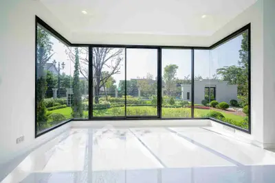 Spacious corner unit with floor-to-ceiling windows offering a stunning garden view.