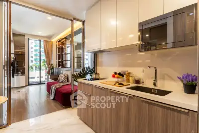 Modern open-layout kitchen with sleek cabinetry and integrated appliances in a stylish apartment.