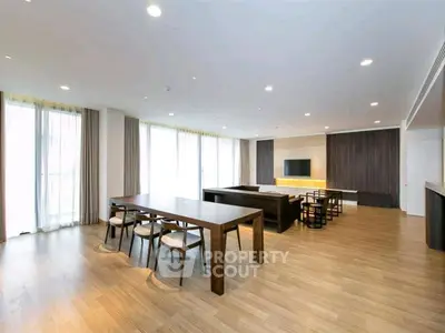 Spacious modern living room with elegant dining area and large windows.
