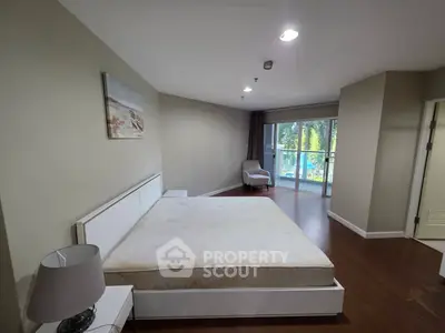 Spacious bedroom with large windows and modern decor