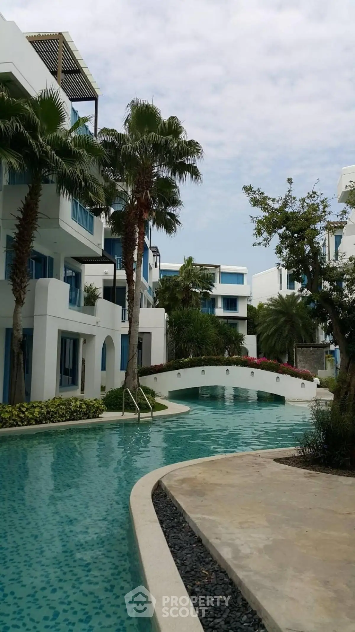 Luxurious residential complex with stunning pool and lush landscaping