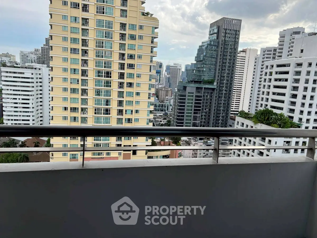 Stunning cityscape view from a high-rise balcony in urban setting.