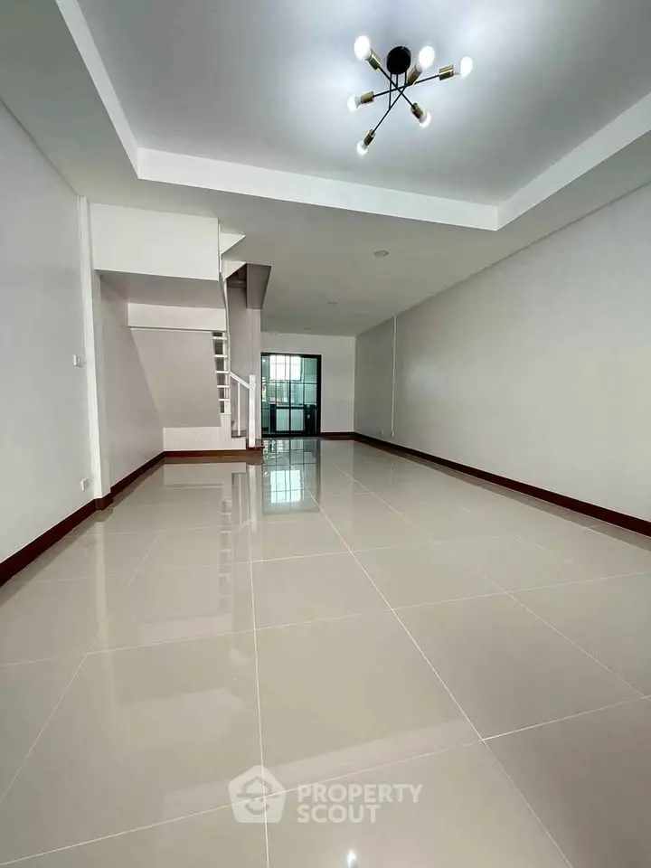 Spacious modern living room with sleek tile flooring and stylish lighting