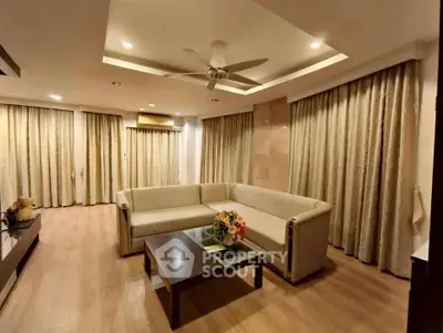 Spacious living room with modern decor and elegant lighting