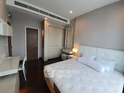 Spacious modern bedroom with elegant furnishings and ample natural light.