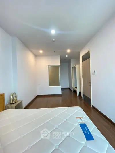 Spacious bedroom with modern design and ample natural light