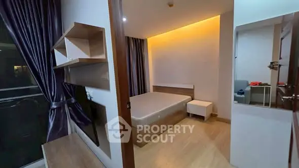 Modern bedroom with ambient lighting and sleek wooden flooring