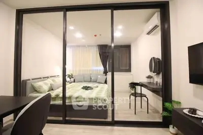 Modern bedroom with glass partition and stylish decor in urban apartment