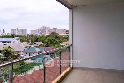 Spacious balcony with stunning cityscape view and modern glass railing