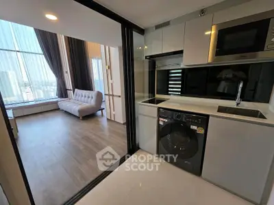 Modern apartment with sleek kitchen and spacious living area featuring floor-to-ceiling windows.