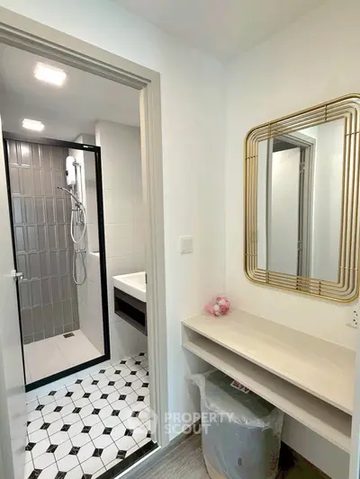 Modern bathroom with stylish shower and elegant mirror in contemporary apartment.