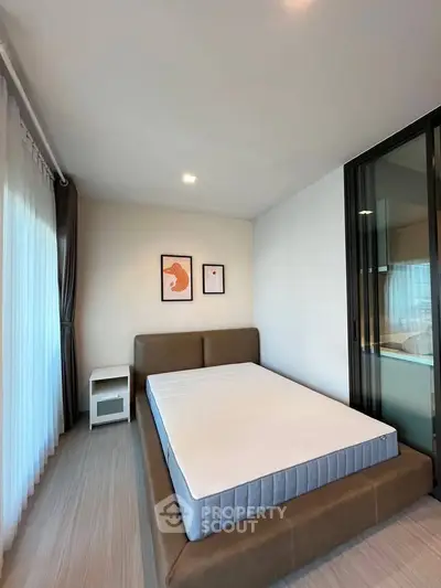 Modern bedroom with stylish decor and large window for natural light
