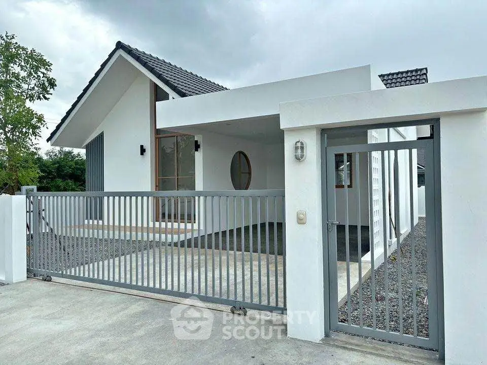 Modern white house with sleek design and spacious driveway, perfect for contemporary living.