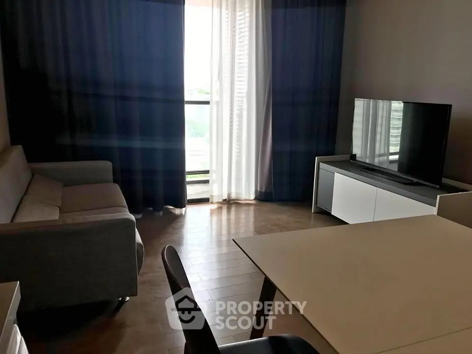 Modern living room with sleek furniture and large TV, perfect for relaxation and entertainment.