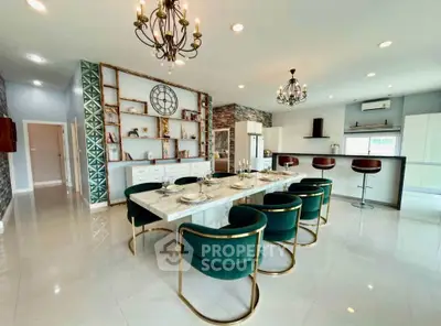 Luxurious open-plan kitchen and dining area with elegant decor and modern appliances.