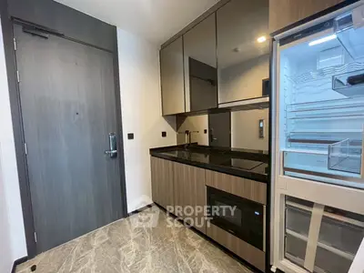 Modern kitchen with sleek cabinets, built-in appliances, and elegant flooring.