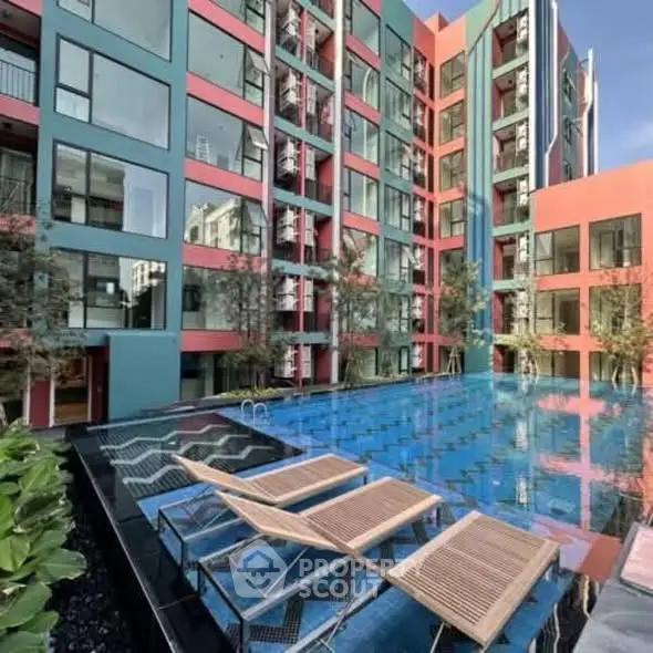 Modern apartment complex with vibrant colors and inviting swimming pool