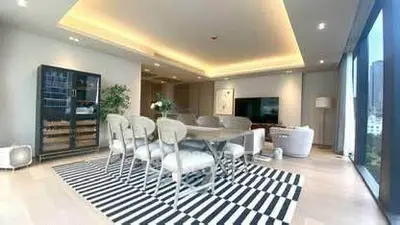Luxurious modern living room with elegant dining area and stylish lighting.