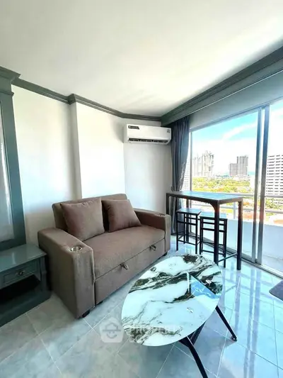 Modern living room with city view, featuring a cozy sofa and stylish coffee table.
