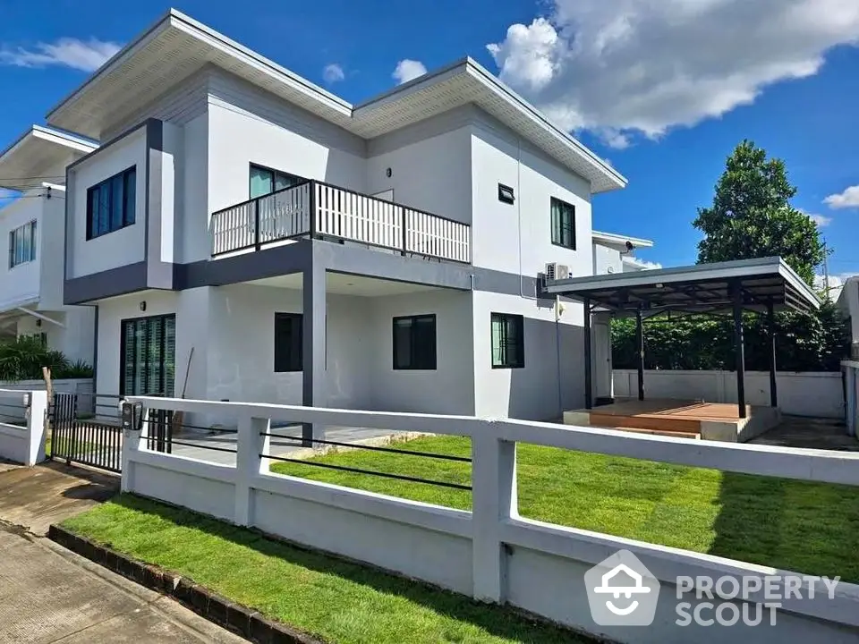 Modern two-story house with spacious lawn and sleek design in a serene neighborhood.