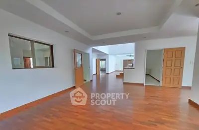 Spacious open layout living area with wooden flooring and modern design