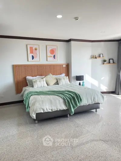 Spacious bedroom with modern decor and natural light