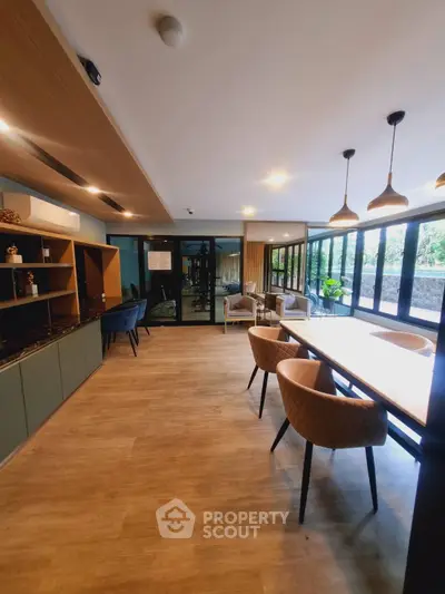 Modern living room with stylish furniture and large windows offering natural light.