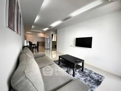 Modern living room with sleek furniture and open kitchen layout