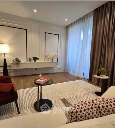 Elegant living room with modern decor, large window, and stylish furniture.