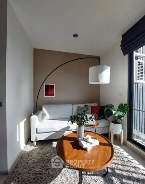 Cozy living room with modern decor and natural light.