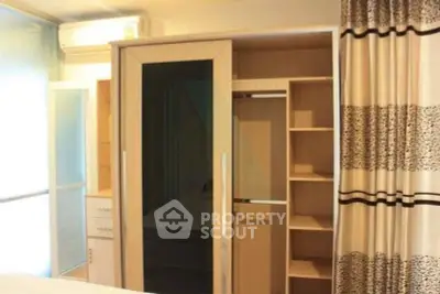 Spacious bedroom with modern wardrobe and air conditioning unit