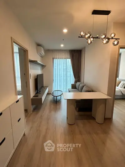 Modern living room with sleek furniture and stylish lighting in a cozy apartment.