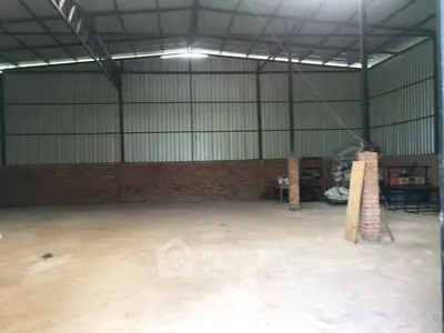 Spacious industrial warehouse with high ceilings and brick walls