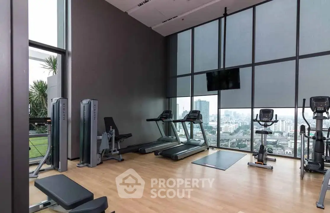 Modern gym with city view in luxury high-rise building
