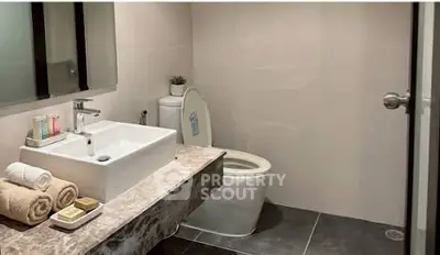 Modern bathroom with sleek fixtures and elegant marble countertop.