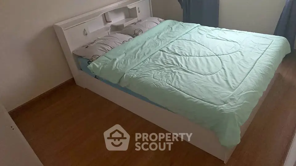 Cozy bedroom with modern bed and wooden flooring, perfect for relaxation.