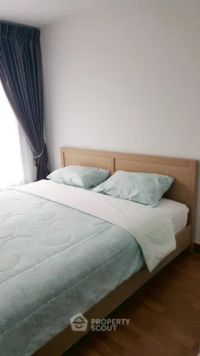 Cozy bedroom with wooden bed frame and elegant curtains