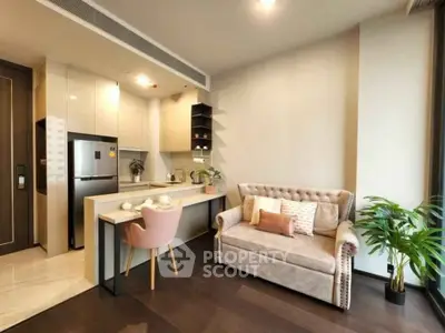 Modern living room with cozy sofa and stylish kitchen in open layout apartment.