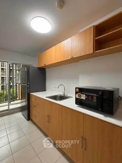 Modern kitchen with sleek cabinets and balcony view