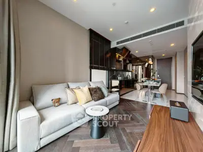 Modern living room with stylish decor and open kitchen layout in luxury apartment.