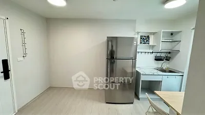 Modern kitchen with sleek fridge and compact dining area