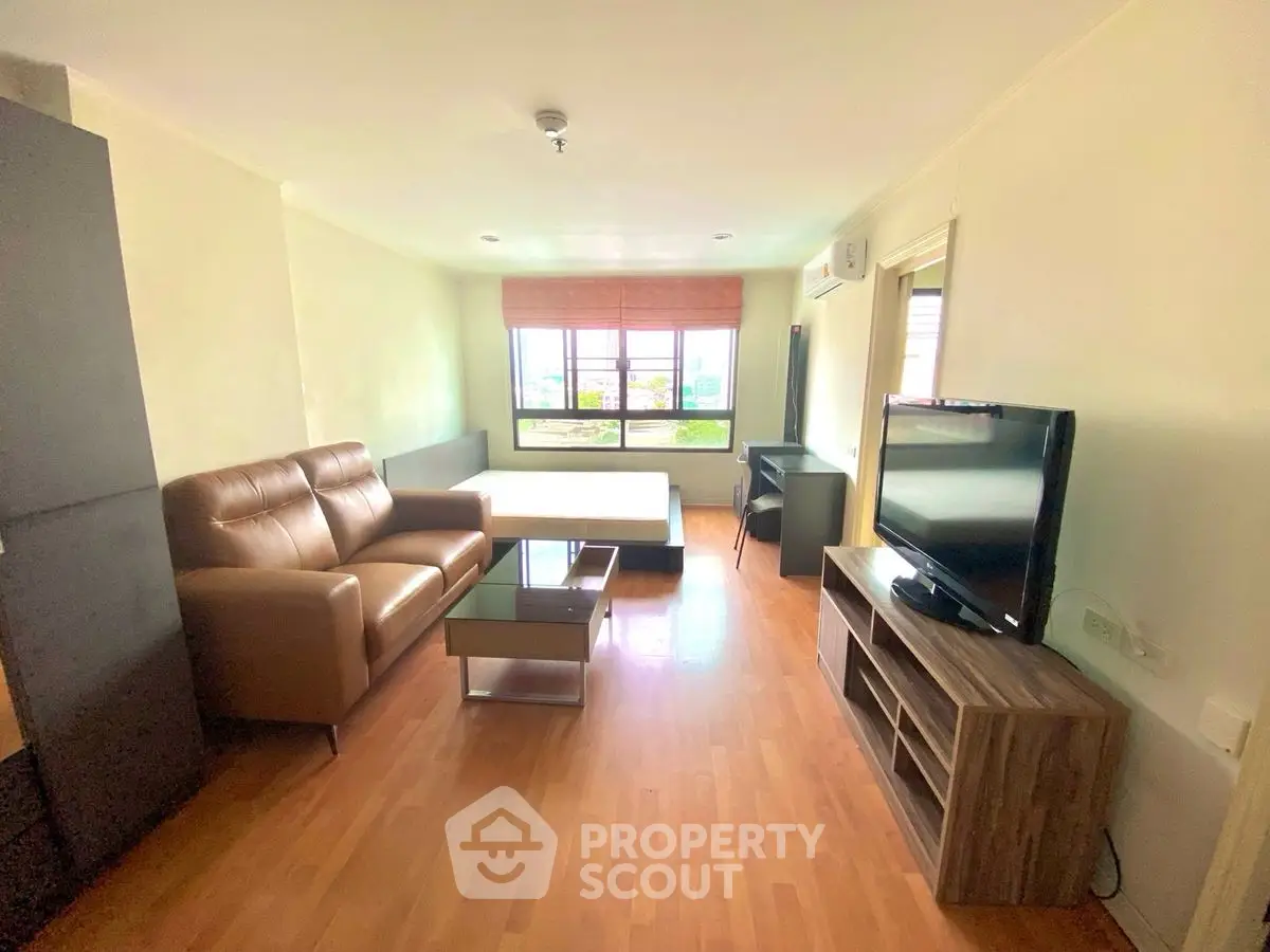 Spacious living room with modern furniture and large window view