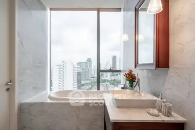 Luxurious bathroom with city view, featuring marble finishes and elegant fixtures.