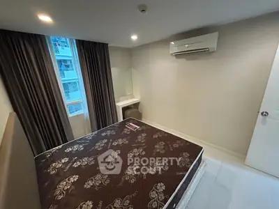 Modern bedroom with air conditioning and large window in a stylish apartment.