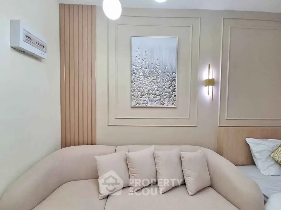 Elegant living room with modern beige sofa and stylish wall art, perfect for cozy relaxation.