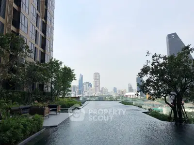 Luxurious rooftop pool with stunning city skyline view in modern high-rise building.