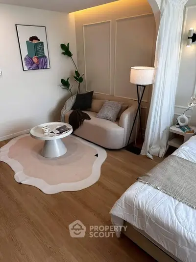 Chic modern bedroom with cozy seating area and stylish decor
