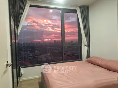 Stunning bedroom with panoramic city view and vibrant sunset sky.